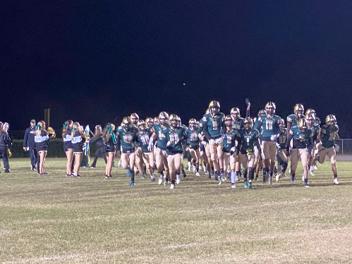 FALCONS RUSH OUT of the end zone before the start of the game. They were lead by seniors on their special night. 