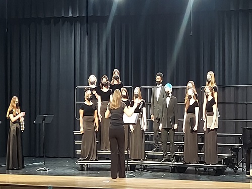 CHORAL STUDENTS RETURNED  to the auditorium stage on Tuesday night for their annual winter concert. Socially distanced and masked, they were able to perform their first face-to-face event since March 2020.