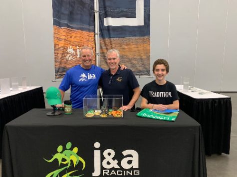 FBLA TEACHER BRUCE Ruddock (middle) attends the J & A Racing competition with some of his student club members. FBLA members were asked to volunteer their time to the event as they hope to, one day, become future business leaders.