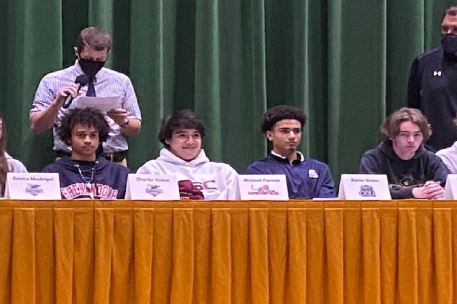 SENIOR SOCCER PLAYERS (left-right) CJ Vakos, Mikey Farmer, Aaron Deans, and football player Tyler Thatch sit back and relax while Assistant Soccer Coach Mr. Duffy sings the praises of his players.  According to Farmer, he felt a since of relief after signing his letter of intent.

