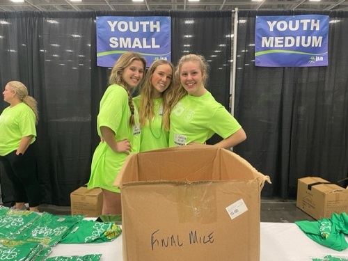 JUNIORS ALLI KASSIR (left), Olivia Harriman, (middle) and Amelia Keck represented the Class of 2023 at the Oceanfronts annual Shamrock Marathon last year by volunteering their time.  This year, all three will return as volunteers, lending their time and effort to a necessary and fun 51st Anniversary race.