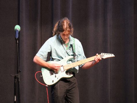 SENIOR WILLIAM BIBEAU, one of many who joined guitar club over the past few years, shows his talent during last years Talent Show. Guitar club welcomes all who enjoy playing or would like to learn how to play the guitar. 