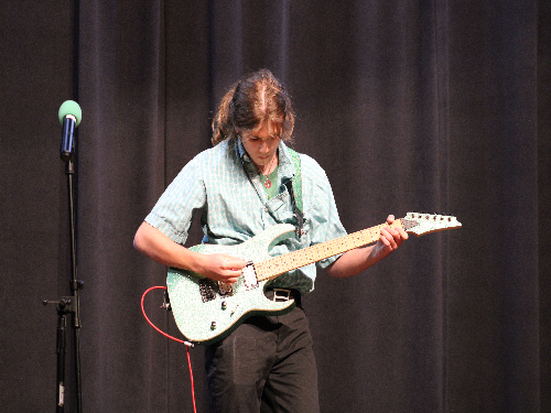 SENIOR WILLIAM BIBEAU, one of many who joined guitar club over the past few years, shows his talent during last year's Talent Show. Guitar club welcomes all who enjoy playing or would like to learn how to play the guitar. 