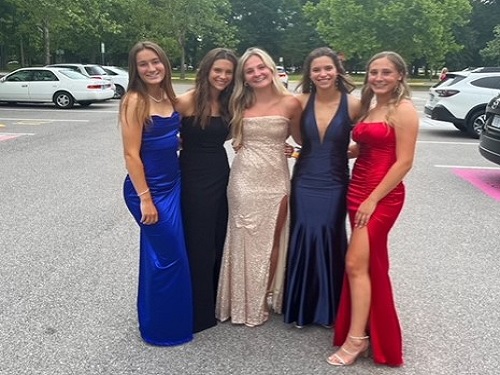 CLASS OF 2023 juniors dress to impress, taking group photos before heading into the gym.  Although Ring Dance is not traditionally held at school, students adapted and still managed to make it a special night.