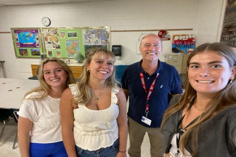 SENIORS CLAIRE MOOREHEAD, Cassie Carbonneau, and Elyse Unger meet Mr. Norquist, a new teacher at Cox,  in his classroom. Mr. Norquists history class is filled with University of Alabama paraphernalia, representing his love for their football program.