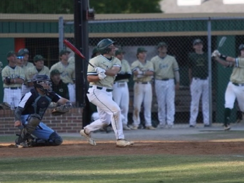 SENIOR RILEY DECANDIDO hits a home run while his teammates watch the ball soar. He knew this big hit would help the team make it to the state championship.