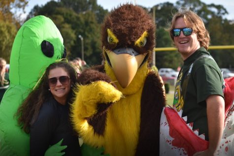 SENIORS NATALIE GEN and Will Slevin get the pepe rally started with the Falcon mascot.  Both Gen and Slevin were clad in costumes as emcees for the rally.