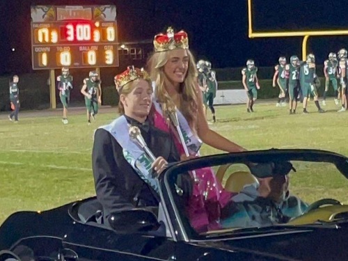 SENIORS RAMEY BOWER and Carter Shupert ride around the track as the newest Falcon Top Royalty during the Homecoming halftime events. Bower and Shupert represented the senior Class of 2023. 