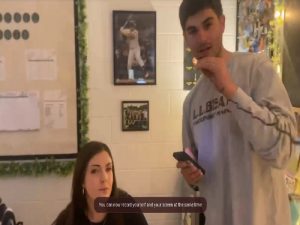 JUNIOR JAKE COLUCCI throws song lyrics at ninth grade Biology teacher Ms. Moresco. She hopes to score a point for the teachers. 