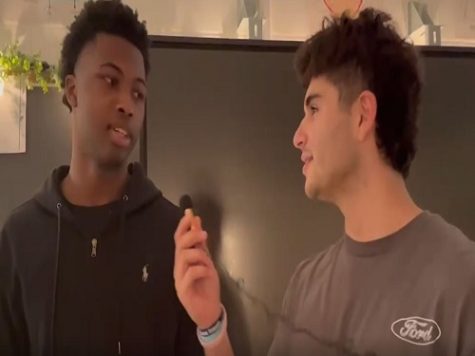 JUNIOR GERARD JOHNSON (left) discusses his favorite traditional Thanksgiving  meal, along with his thoughts on who might win the Cowboys vs. Giants game that day.  People are seemingly more interested in football than in 
eating.