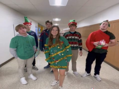 STUDENT COUNCIL MEMBERS film a spirit day announcement video to advertise the week on social media. Seniors Evan Ruddock (left) and Erin Bailey (middle), along with other SCA members show off their ugly sweaters.