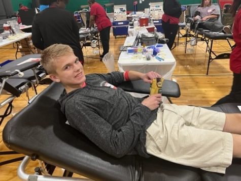 JUNIOR REX LEMMON nourishes his body after giving a pint of blood to American Red Cross. The blood given by CHS students will help those who need it in the community.