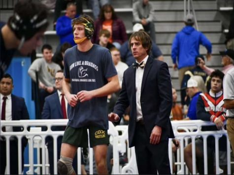 HEAD COACH DALTON Head stands next to senior Parker Tillery awaiting for the next matchup. Tillery placed highest, earning second place in the tournament.