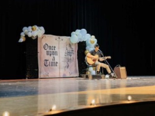 SENIOR NOAH CALAYO strums the guitar at the annual Best of Cox event.  As the event is partly a talent show, He 
performed his best talent for the audience to enjoy.