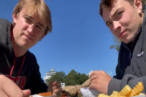 JUNIORS BLAKE HESELIUS and Max Palmerton grub on Uncle Als legendary sandwiches together on a bench outside a park. They ordered the garbage burger, hotdogs, and the fan favorite home fries.