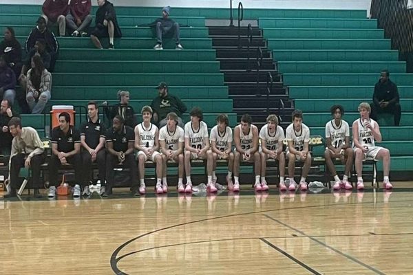 CHS FALCON BASKETBALL team sits on the bench to rest before game play begins. The Falcons went on to win the game with hopes of adding more Ws to their record.