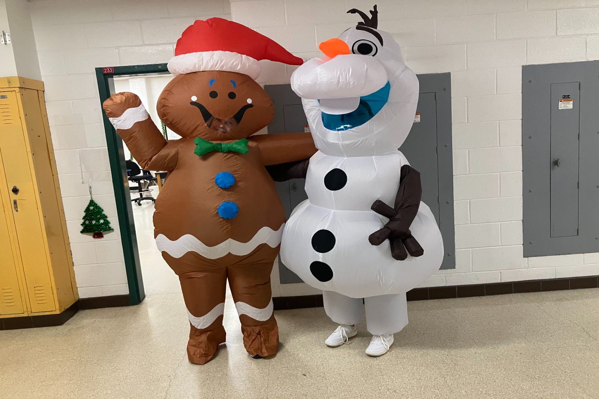 BIOLOGY TEACHER MISS Moresco and Security Guard Mrs. Carlson came out in full costume for winter spirit week. Moresco and Carlson both wore  inflatable costumes to represent a gingerbread Santa and Olaf from Frozen.