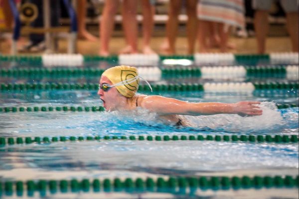 SENIOR BAILEY GRAY uses all her strength to get across the pool and win the swim competition. Her passion for swim has shaped her into who she is today. 