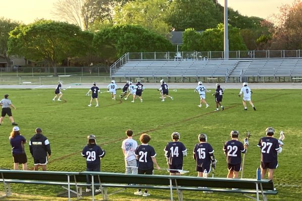 THE BOYS LACROSSE team looks to score against opponent Ocean Lakes. The Falcons took over the game with a 15-2 win.