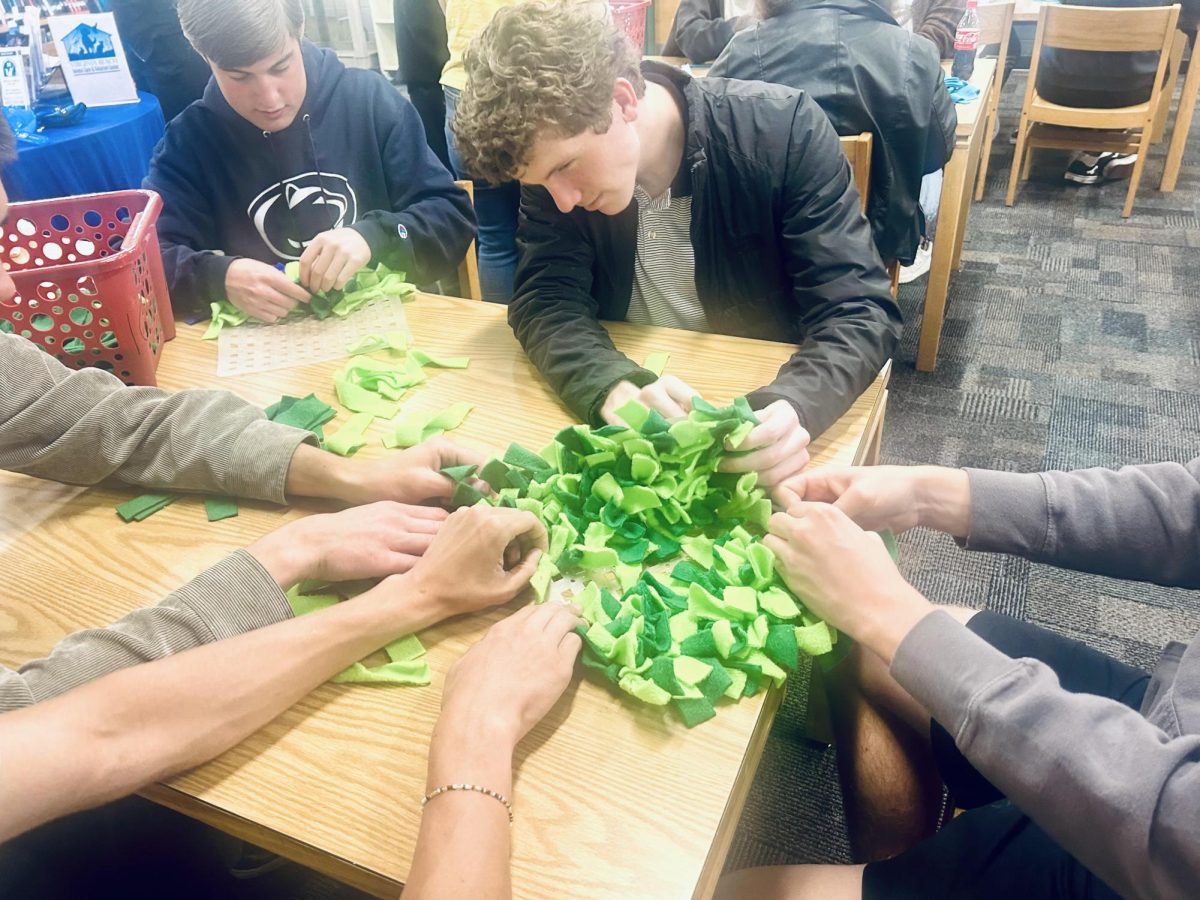 SENIORS (LEFT TO Right) Chase Foster and Luke Rhoades create snufflemats for the Virginia Beach Animal Care and Adoption Center (VBACAC). These snufflemats will be given to VBACAC to be sent to animals in need.