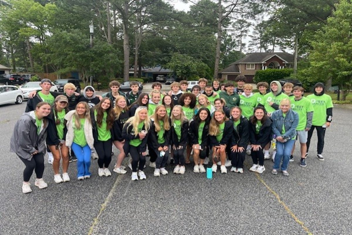 BOYS AND GIRLS Falcon soccer teams joined forces last weekend to volunteer at the DFeet Cancer 5K run/walk for the Dalton Fox Foundation.  The teams gathered in the pouring rain to act as course marshals and to cheer on the participants.