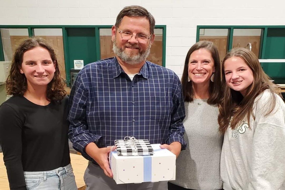 CORE AND HONORS Geometry and Advanced Placement (AP) Statistics teacher Mr. Irwin celebrates his Teacher of the Year Award with his family last week. In addition to his eight years at CHS, Irwin taught Norfolk middle school students for nine years, and worked as an administrator at Norfolk Public Schools for four years. 