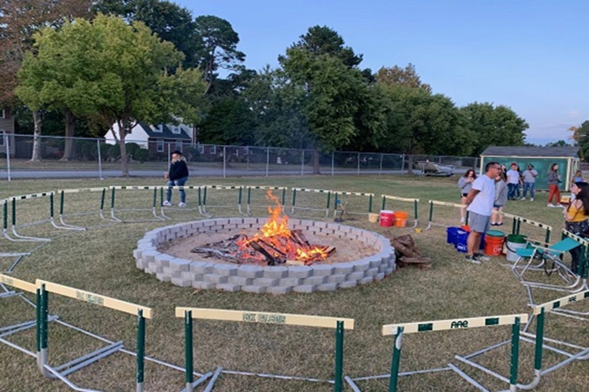 STUDENTS AND TEACHERS build a bonfire that will be used to initiate the Homecoming week festivities on Monday.  Several teachers will supervise the event and keep the fire going, while student clubs and teams perform, present and offer snacks to the crowd.