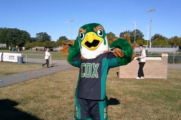 FALCONS MASCOT FLEXES at the Homecoming pep rally. "The pep rally was a great way to hype up students for the Homecoming football game," senior Max Palmerton said.