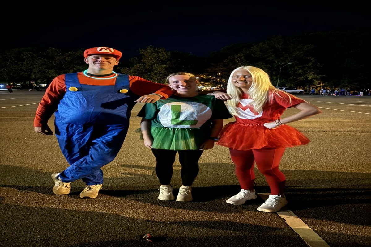 SENIORS BRAY LYONS (left), Katie Linderman, and Ireland Rich dressed up  in their [respective] costumes last week at Boo Bash. They spent their night handing out candy to all the kids who showed up to trick-or-treat.