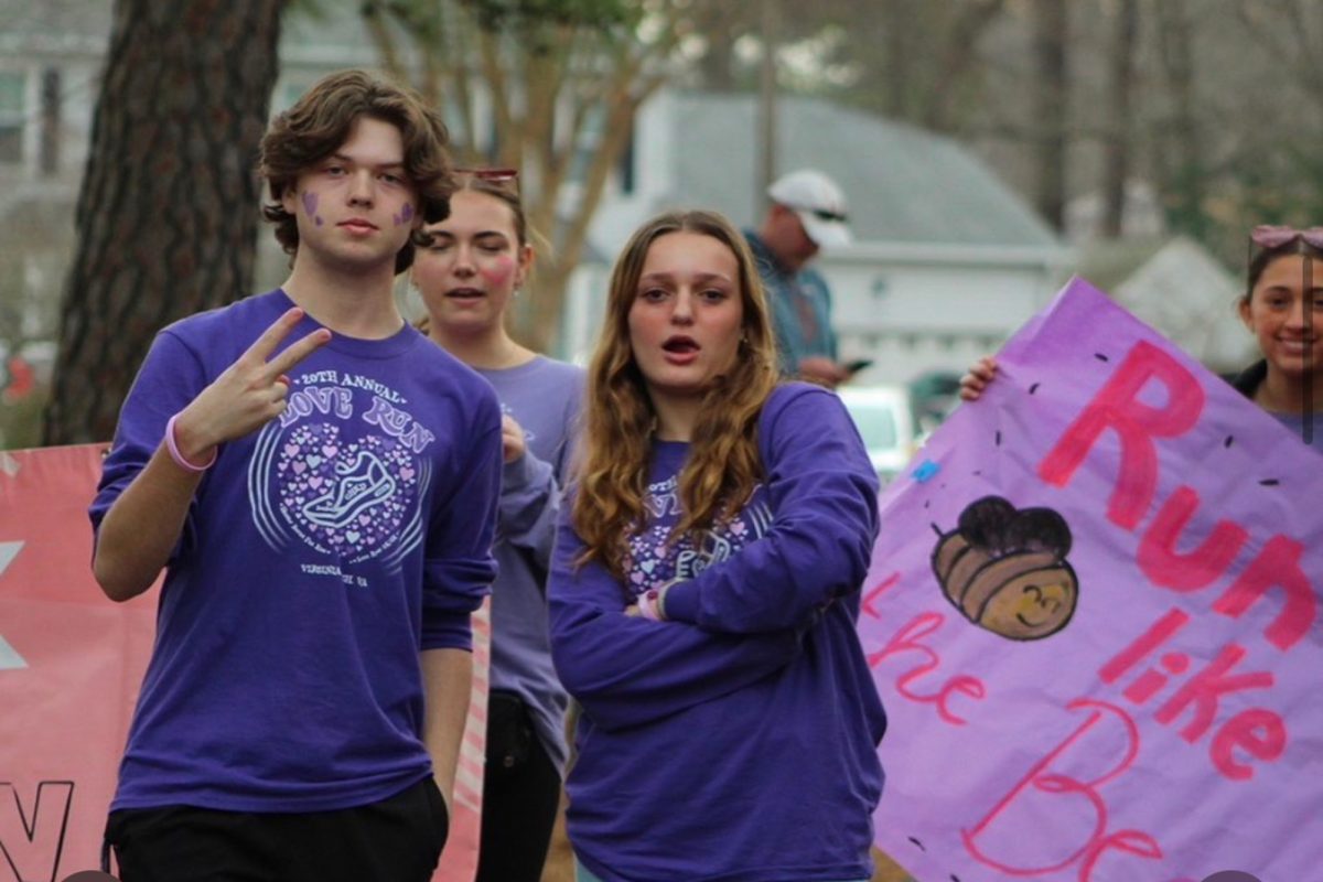 SENIOR BRADY DUNN works the SCA Love Run for the  third year in a row. Dunn readies himself to cheer on all the participants in the race. 