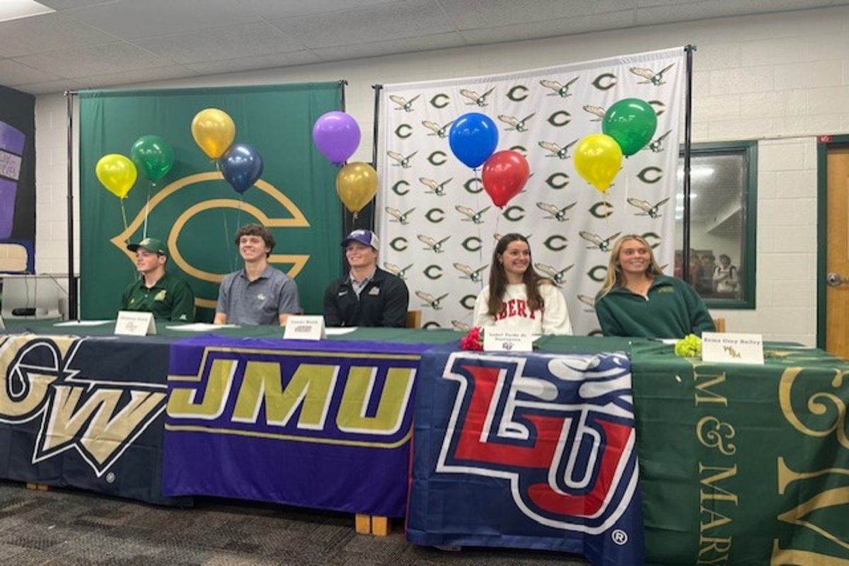 CHS SENIOR ATHLETES (left-right) Seniors James Godfrey, Christian Dewey, Conner Worth, Isabel  Pardo, and Erma Grey Bailey sign letters of intent for their chosen college. Godfrey, Dewey, and Worth committed for baseball, and Pardo and Bailey committed for field hockey. 