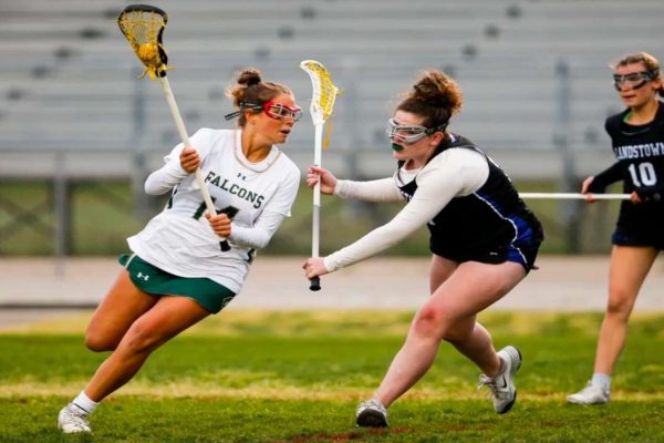 SENIOR LEENA HARKIN cuts down the field with the ball. The team earned a victory against the Eagles of Landstown High School. 