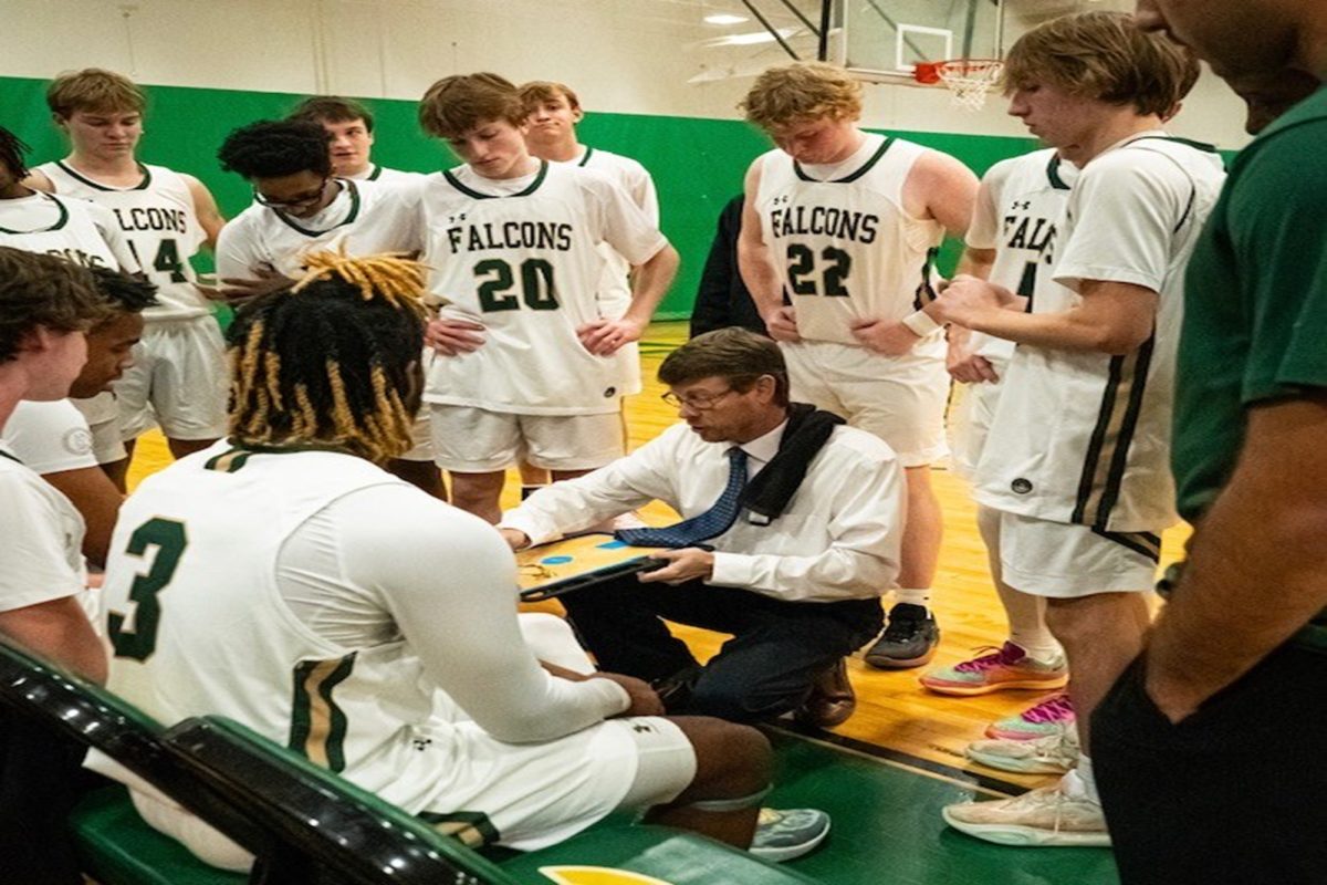 COACH WOLFE PREPARES for an important second half that could make or break the game. Wolfe offered his experience and some advice for more pivotal plays for his players using the whiteboard. 