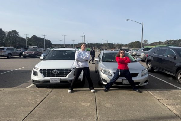 TWO NEWLY LICENSED student drivers guard their cars with their lives in the junior lot after school.  Unfortunately, many accidents involving students occur in this lot as many students are new to the road.