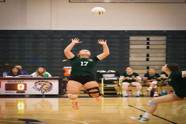 SENIOR OLIVIA FORTIER sets up the ball for a spike. The crowd cheered as the Falcons earned the point to win the set. 