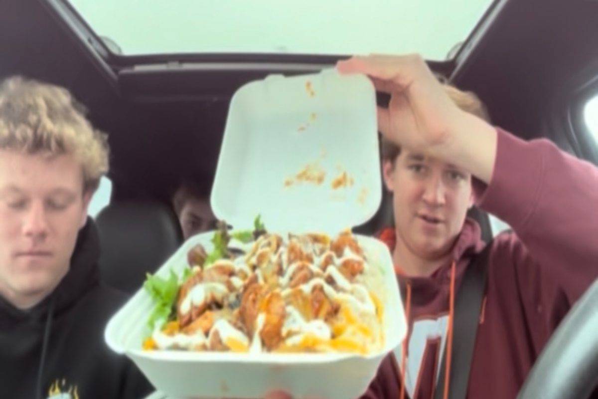 SENIORS BLAKE HESELIUS (right), Christian Braithwaite (left), and Hayden German (back) enjoy the Jerk Shrimp Bowl from Carib Shack. The Carib Shack on Shore Drive has a wide variety of bowls, sandwiches, and burgers; choices for almost everyone.