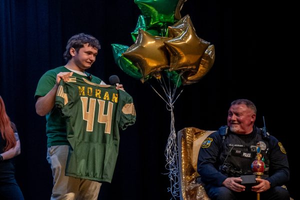 JUNIOR ANDREW LUPIEN awards Officer Moran with his own CHS jersey, as a gift for his courageous acts over the years, as well as for helping him through a major loss.  The national award, "dude, be nice", won by Moran, showed a humble and appreciative man, sitting on his throne as people within the school thanked him for all he does in and out of school. 