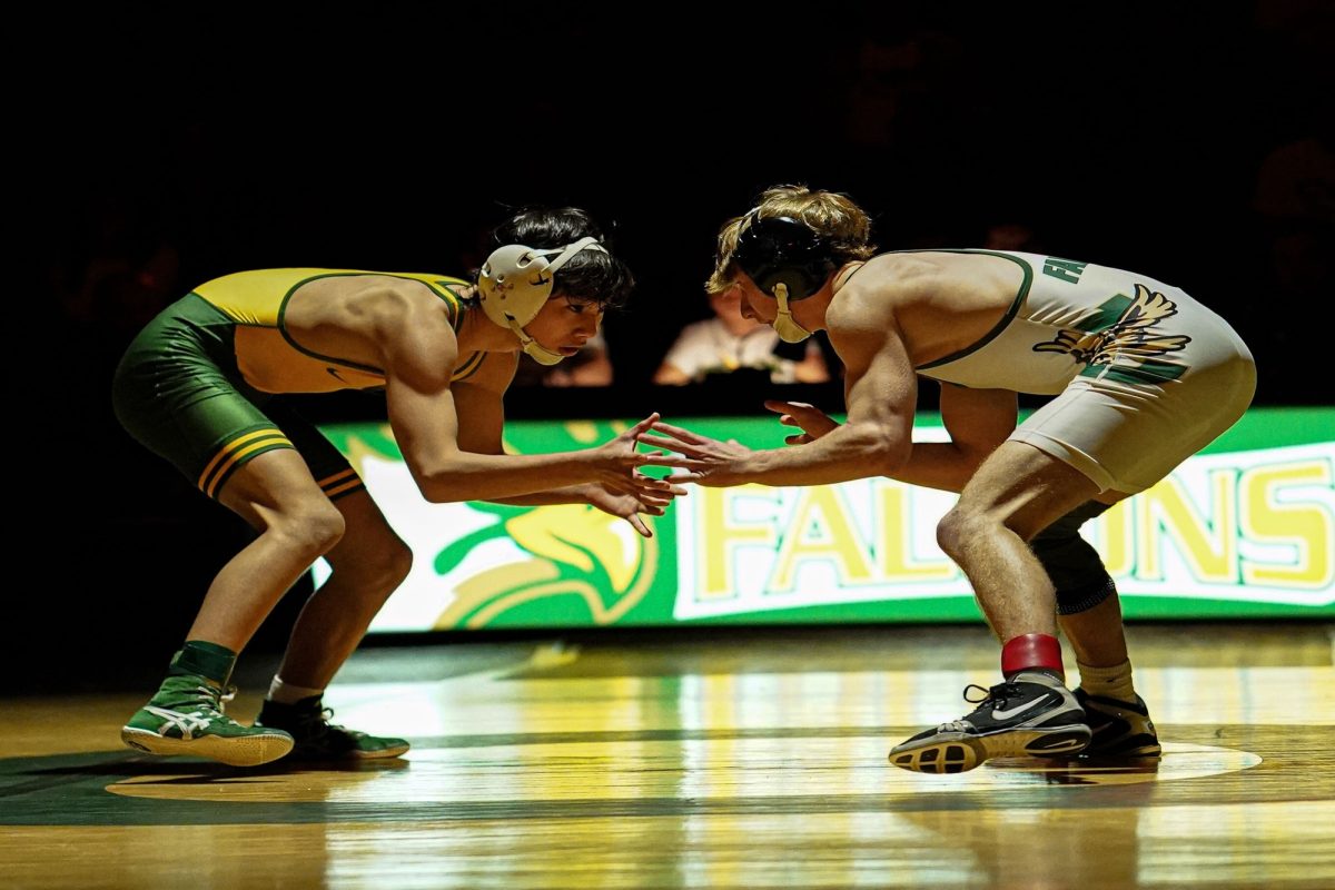 SENIOR AIDEN DOUGHERTY (right) sparred with a Great Bridge wrestler, in the 106 ib. weight class, at a recent home match. Dougherty ended the match with an overtime win.