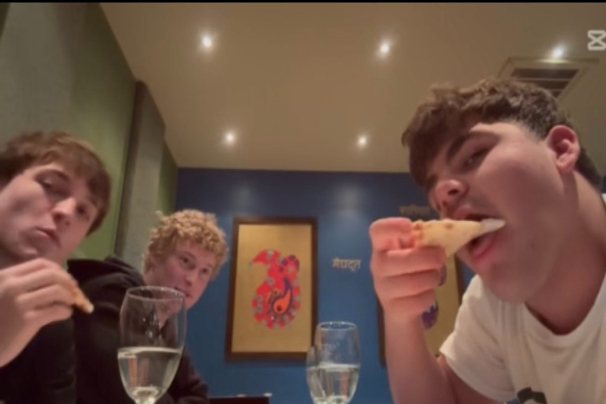 THE FOOD REVIEW squad synchronizes bites of assorted bread at the Nawab restaurant. Junior Jacob Palmerton and sophomore "The General" enjoyed their bread so much that they decided to order more.