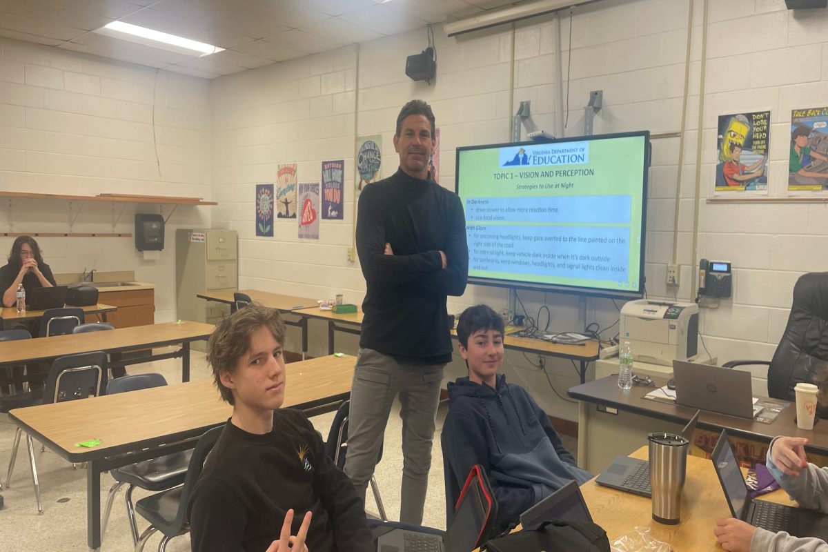 HEALTH AND PE II and Driver's Education teacher Mr. Ingram informs students about safety on the roads in one of his 10th grade classes. He pushes his students to drive safely for the sake of themselves and others. 
