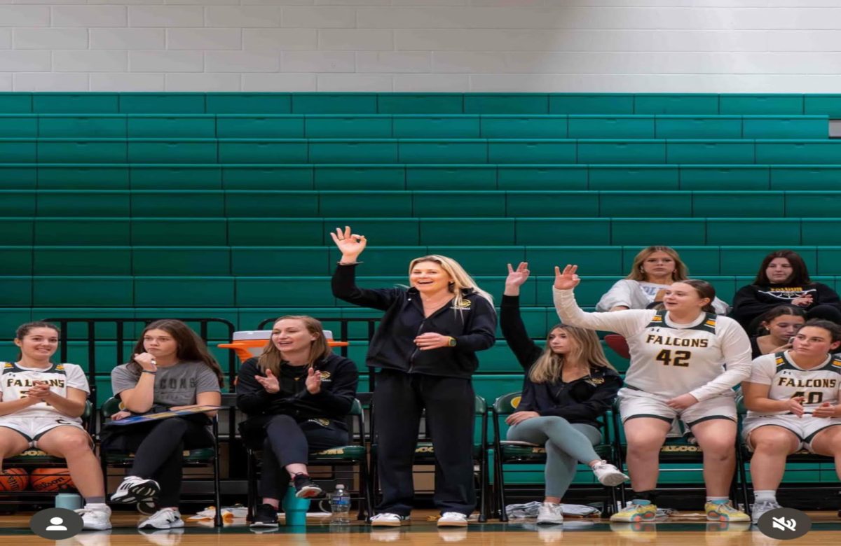 PE AND HEALTH teacher Ms. Matulewicz coaches a girl's basketball game during the winter season. She uses her passion for basketball as a kid to motivate her players. 