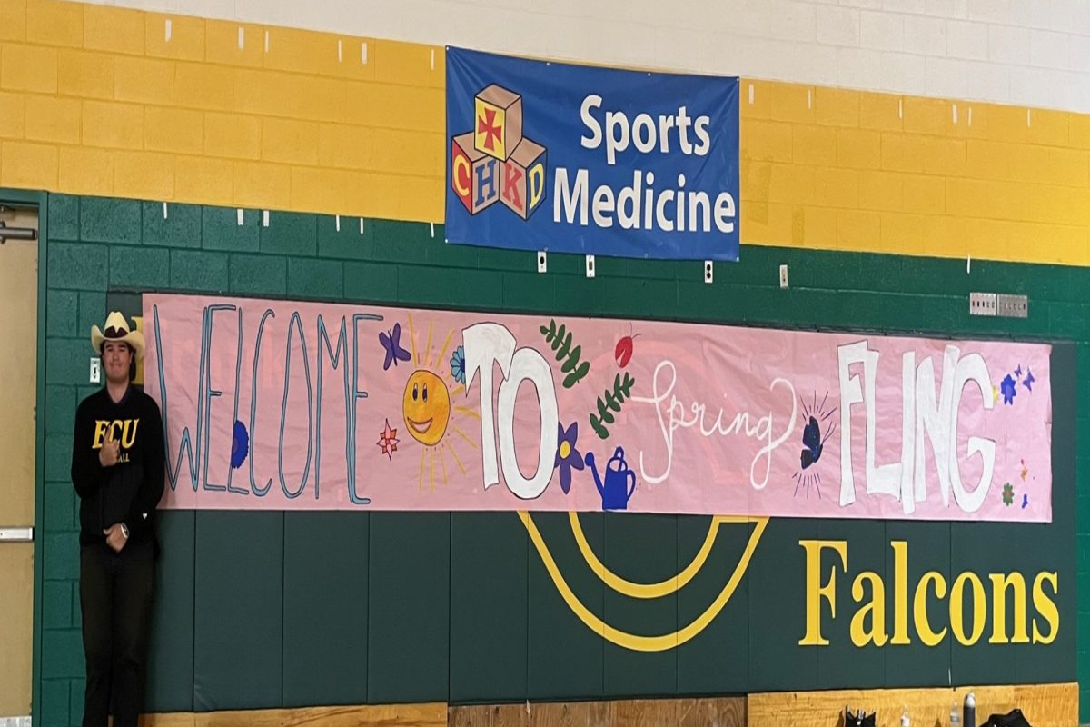 JUNIOR            assists Team Coffee Shop, the school's Leadership class, and VTfT students in decorating the gym for the first-ever "Spring Fling" event. Students were invited from schools throughout VBCPS to join in the special activity that some students may not have had the opportunity to enjoy. 