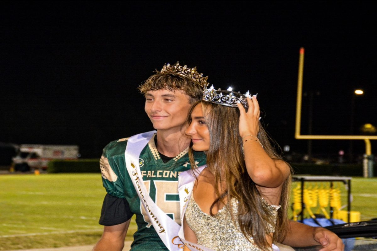 SENIOR BRYCEN WIDHALM wore his Homecoming king crown with Falcon pride. Widhalm and senior Lolita Lolaj were cheered on by the 'Nest 'as they rode through the homecoming parade. 