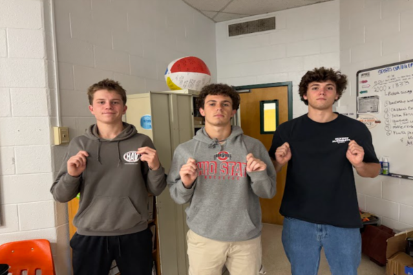 SENIORS NATE WALLACE and Zane Perry, along with sophomore Wyatt German (middle) show students some of the clothes they could potentially swap on Saturday. While the boys don't plan on donating the clothes they are wearing, they do have other items to donate.