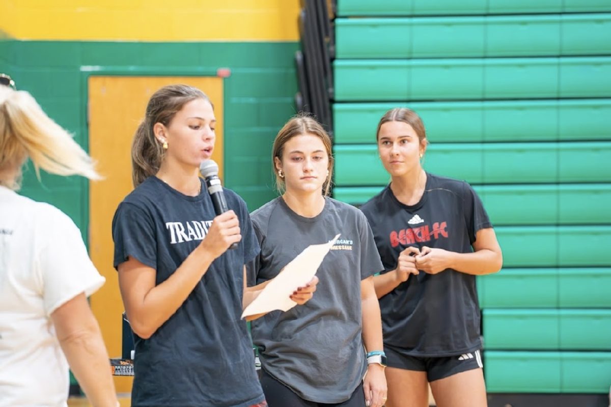 SENIOR AVA DOVE (middle) and juniors Lainey Kimnach and Harper Wilbricht spoke to the crowd before the Morgan's Message volleyball games kicked off. The purpose of the game was to raise awareness for student athlete mental health. 