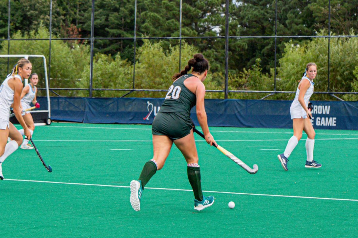 SOPHOMORE BELLA GLENN runs the ball down the field  to the opponent's goal. Glenn's coachability, athleticism, and grit bring the team to another level.