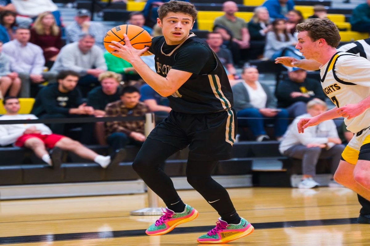 SENIOR CAPTAIN OWEN Jones shields the ball against crosstown rival, First Colonial High School. The leadership he brings to the court was appreciated by his teammates. 