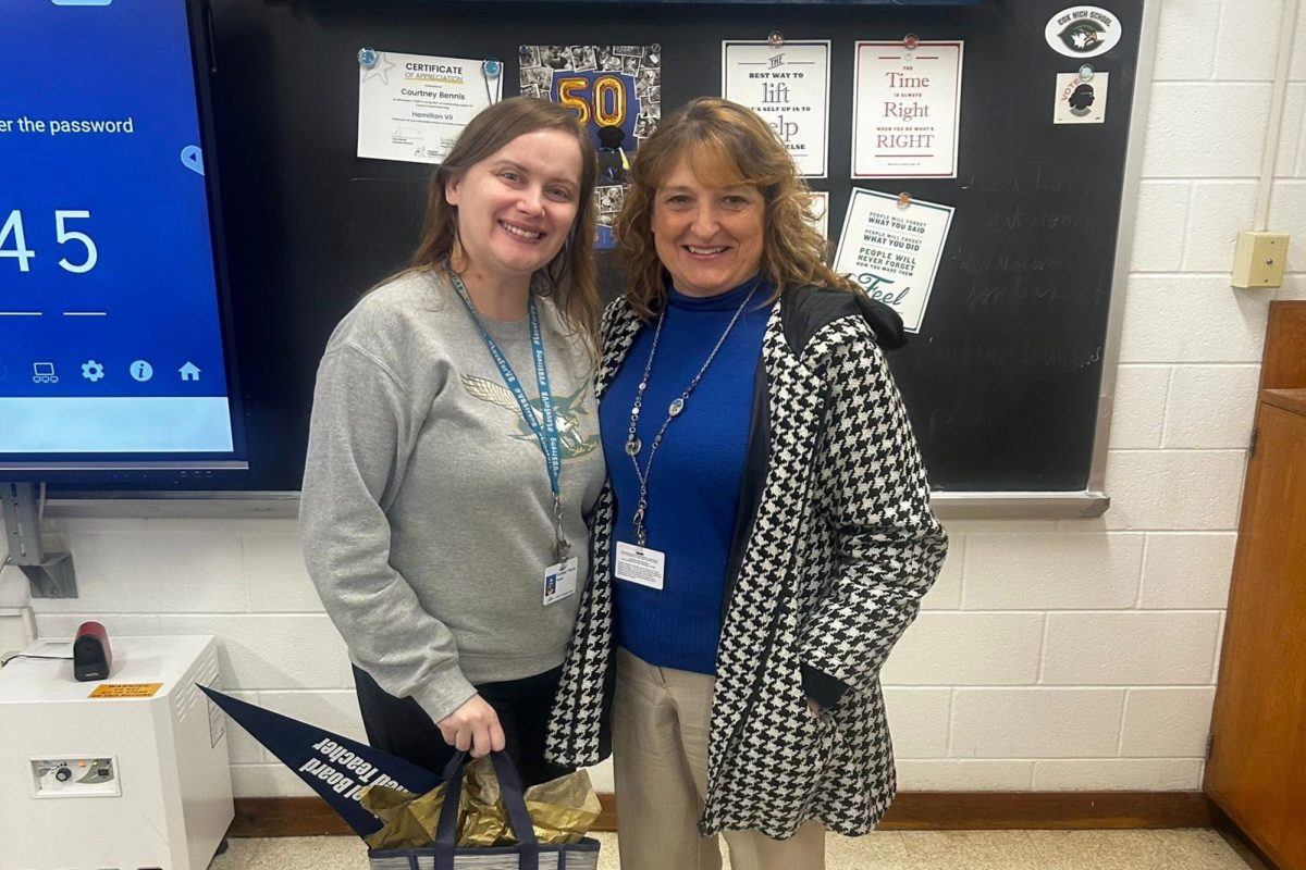 HISTORY TEACHER COURTNEY Bennis (left) and Shelly Erbland celebrate Bennis's new National Board status. The advanced award is proudly recognized by the school, as well as her colleagues and students. 