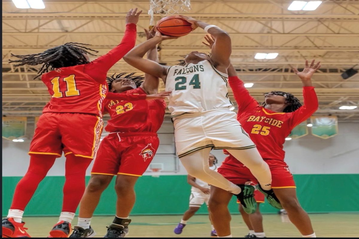 SOPHOMORE MARC WATKINS goes up for a contested lay-up against three Bayside defenders.
The basket was scored by Watkins, which gave the Falcons a 10-point lead