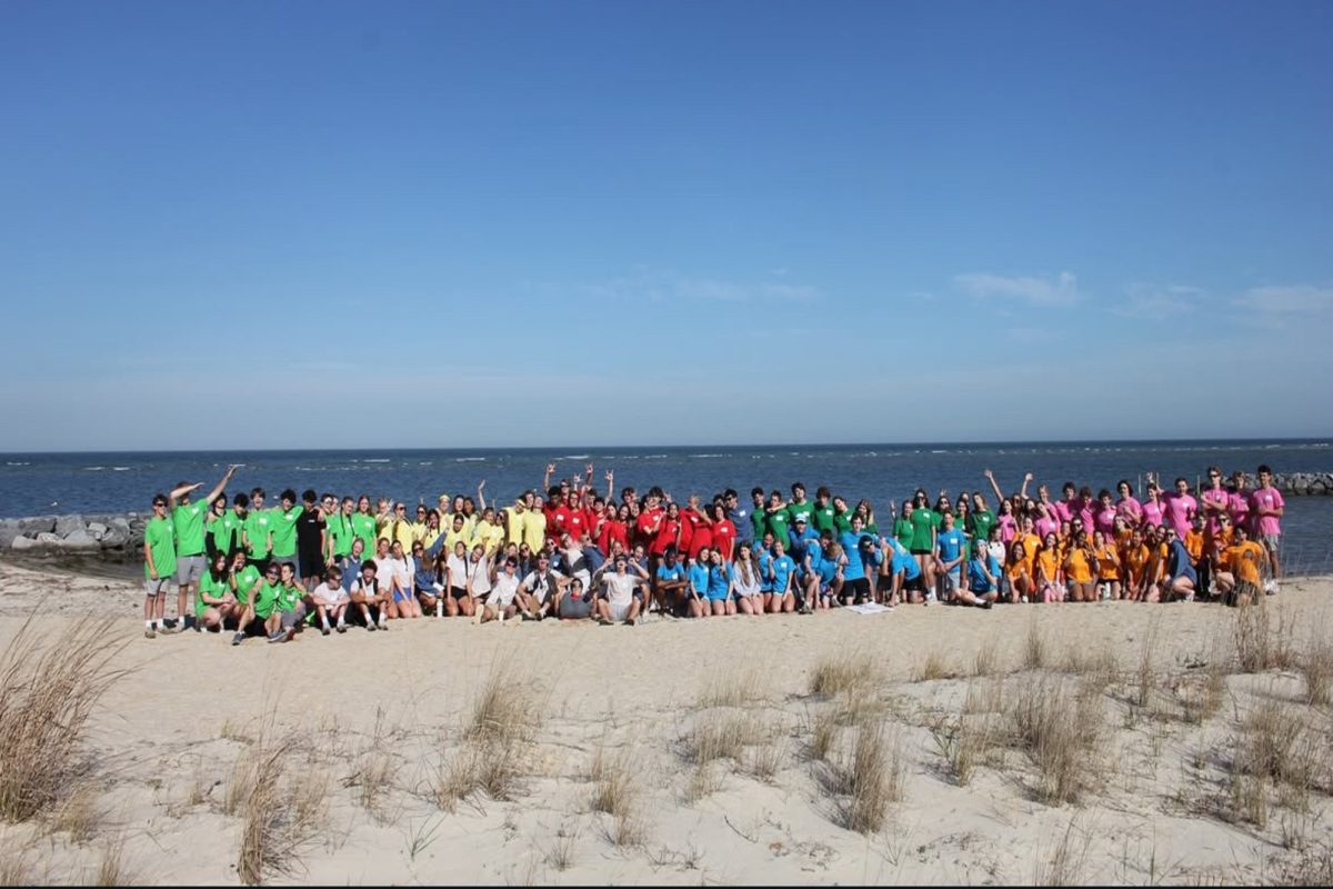 LEADERSHIP WORKSHOP ATTENDEES gather at the beach for a bit of team bonding before the annual Leadership round-up. The soft, warm sand and the beautiful blue skies are a testament to the fun they will have during their camp. 